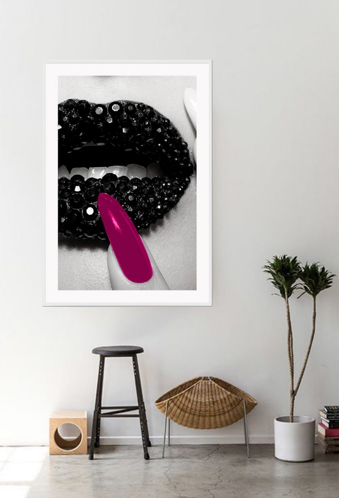 Fashion print of close-up diamond covered lips in black and white with a hot pink fingernail touching mouth