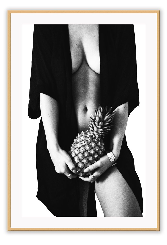 Fashion photography print with nude sexy woman wearing robe holding pinapple in black and white on white background 