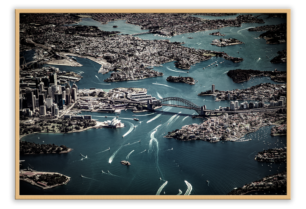 Birds eye view of sydney harbor with dark blue water and grey land  