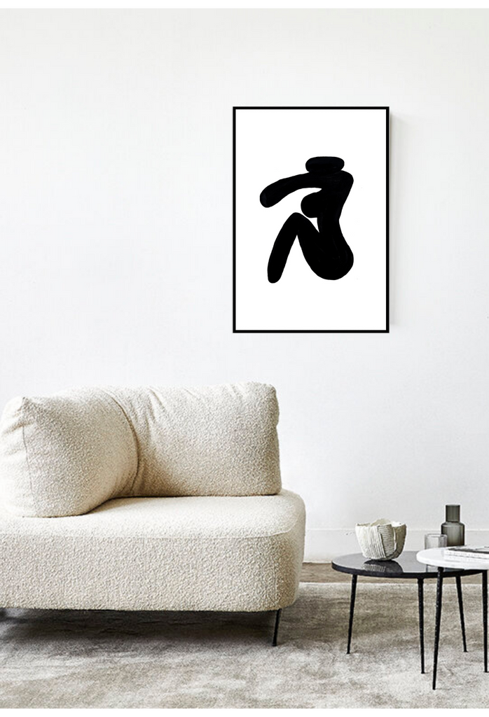 An abstract wall art with a black ink woman figure sketch on dusty yellow background. 