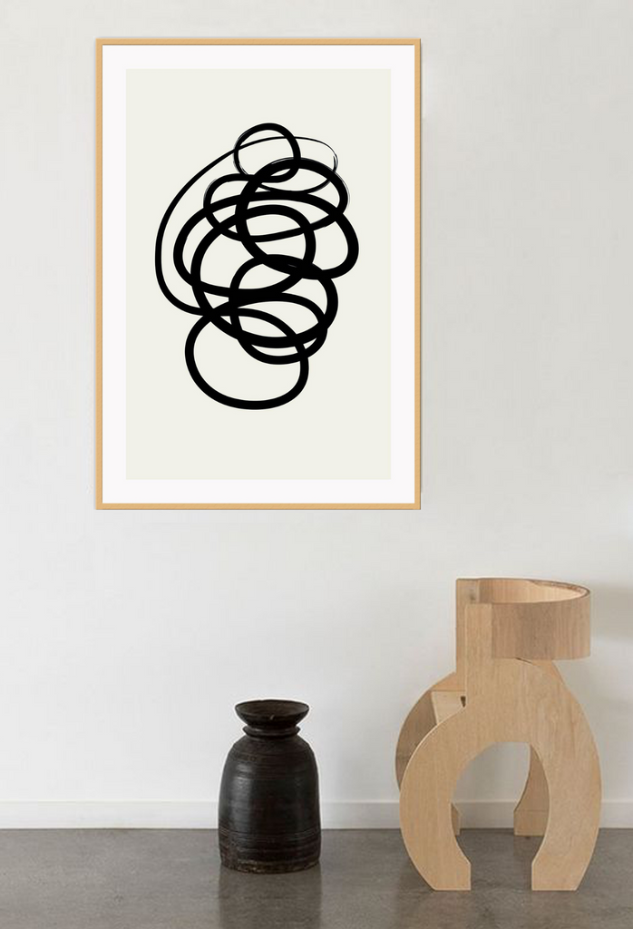 Abstract black and white squiggle print with textured black line and cream background 