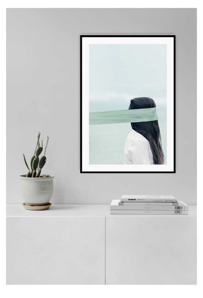 Photography of woman by the ocean wearing a blindfold with light blue tones and dark brown hair 