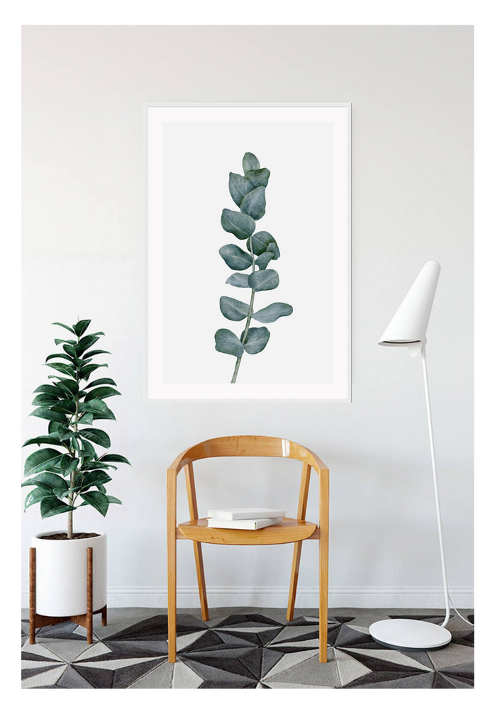 A natural wall art with a green sketch of Eucalyptus plant leaf bunch on white background.