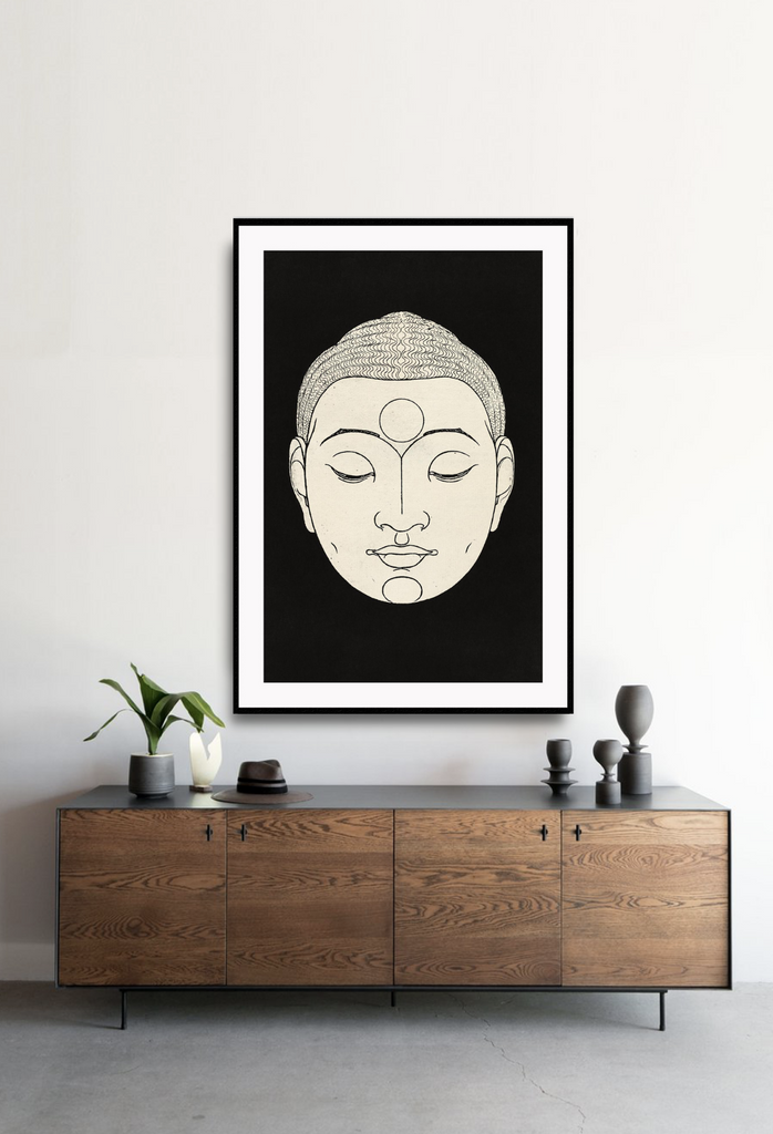 Zen modern minimal style print with a cream buddha face with eyes closed on a black background.