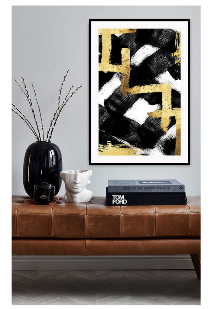 Abstract print with gold vertical and horizontal lines on big black crosses in brushstroke texture and a white background.