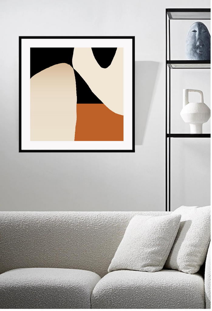 Abstract art print with two chunky round shapes in cream on a half black half rust background.