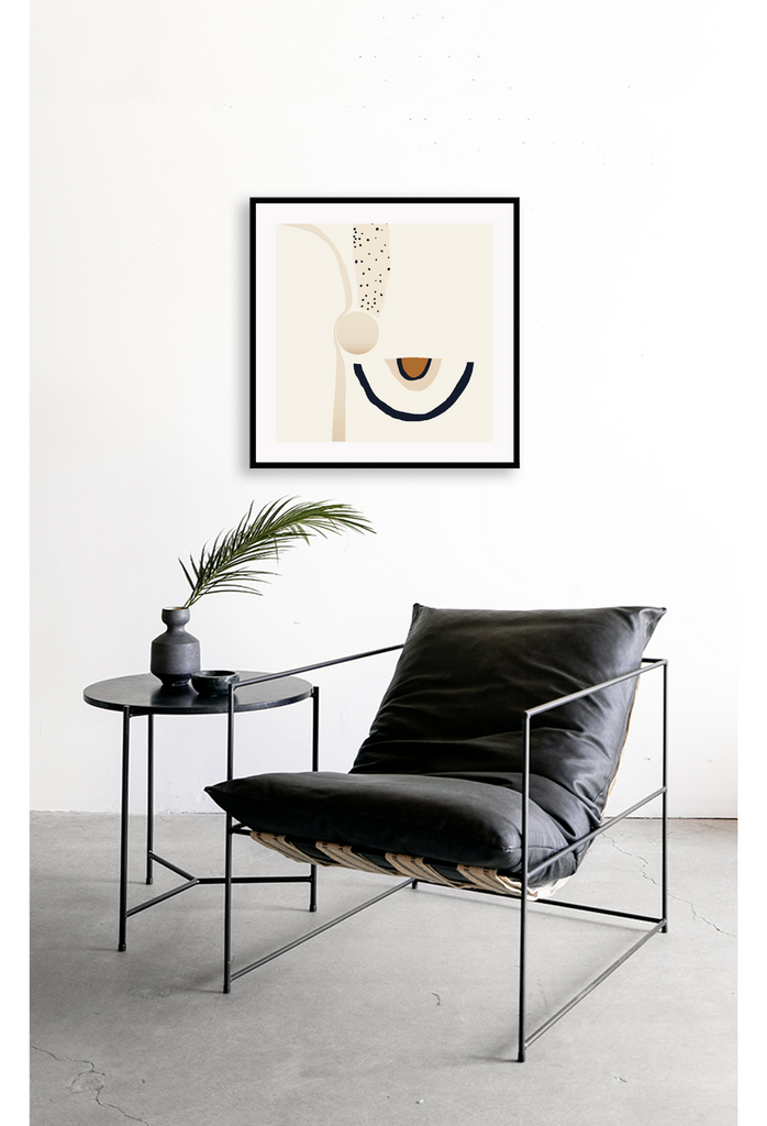 Abstract art print with chunky black and beige curved lines complemented by round shapes on off white background.