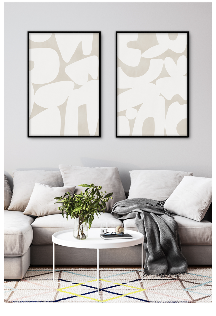 Minimalistic abstract art print with large white round shapes in random formation on plain cream background.