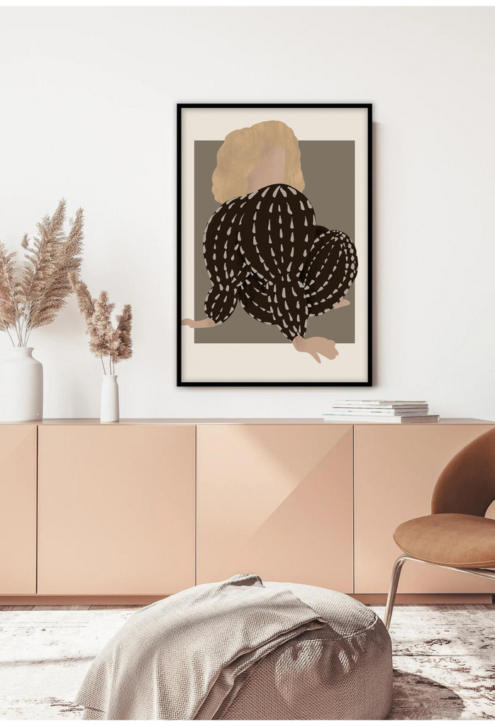 Surrealistic art print with a person in a black and beige patterned outfit sitting in the center looking over her shoulder.
