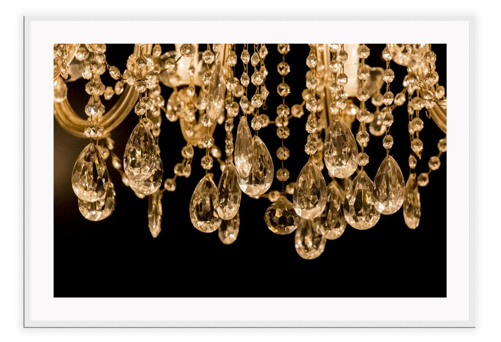 Close up photography of gold crystal chandelier with black background 