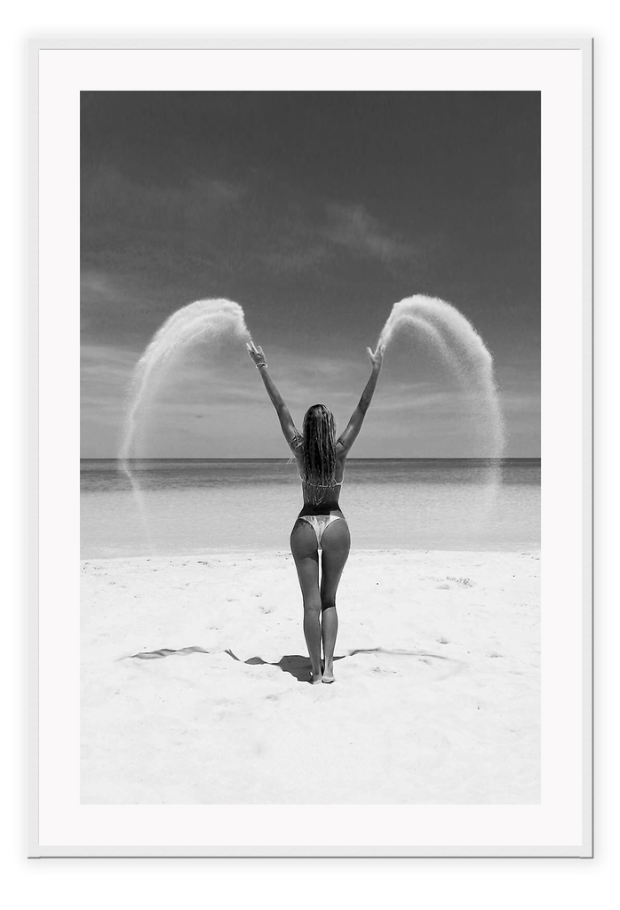Sexy lady woman throwing sand on a beach in black and white, coastal ocean. 