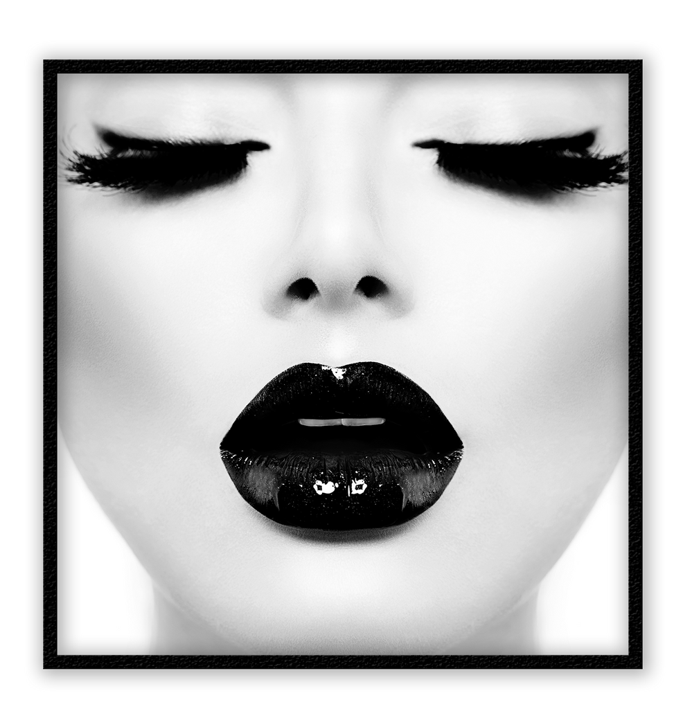 A fashion black and white wall art with a sexy lady's face with full, long eye lashes and dark lips. 