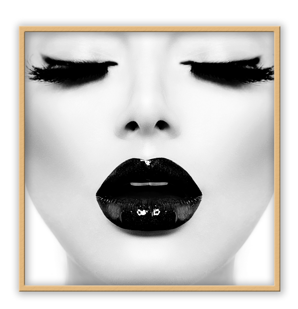 A fashion black and white wall art with a sexy lady's face with full, long eye lashes and dark lips. 