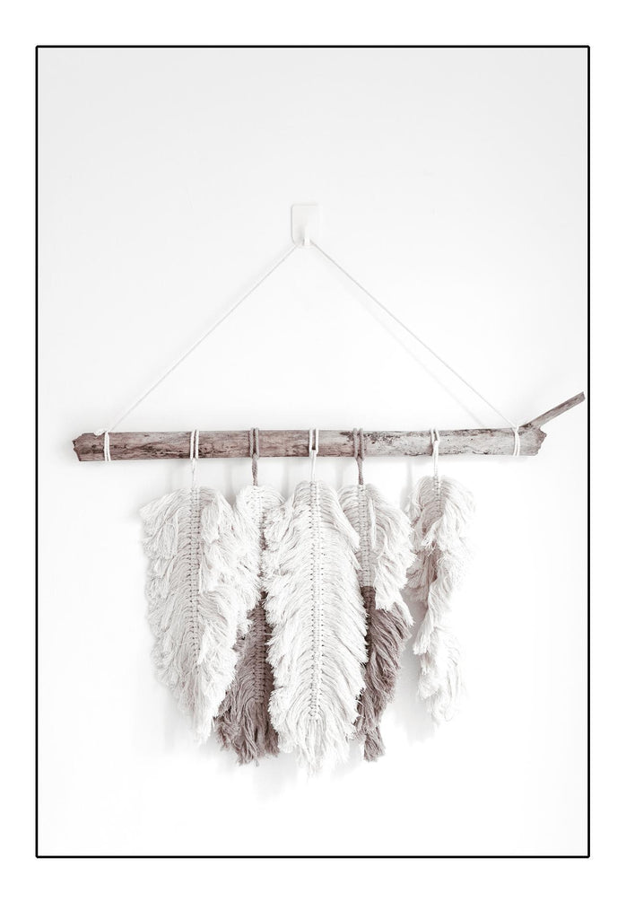 Boho print of feathers stick hung on white background portrait minimal texture 