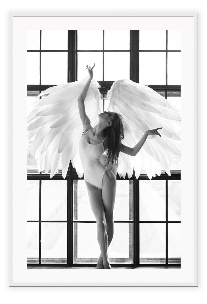 A fashion black and white wall art with the breath of the sun penetrating through big frosted window, back-liting an angel-like bellerina dancing with white feather wings and white leotards.  